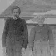 Martin Schlachter and Justina Tschosick in front of their shack near Granlea, Alberta